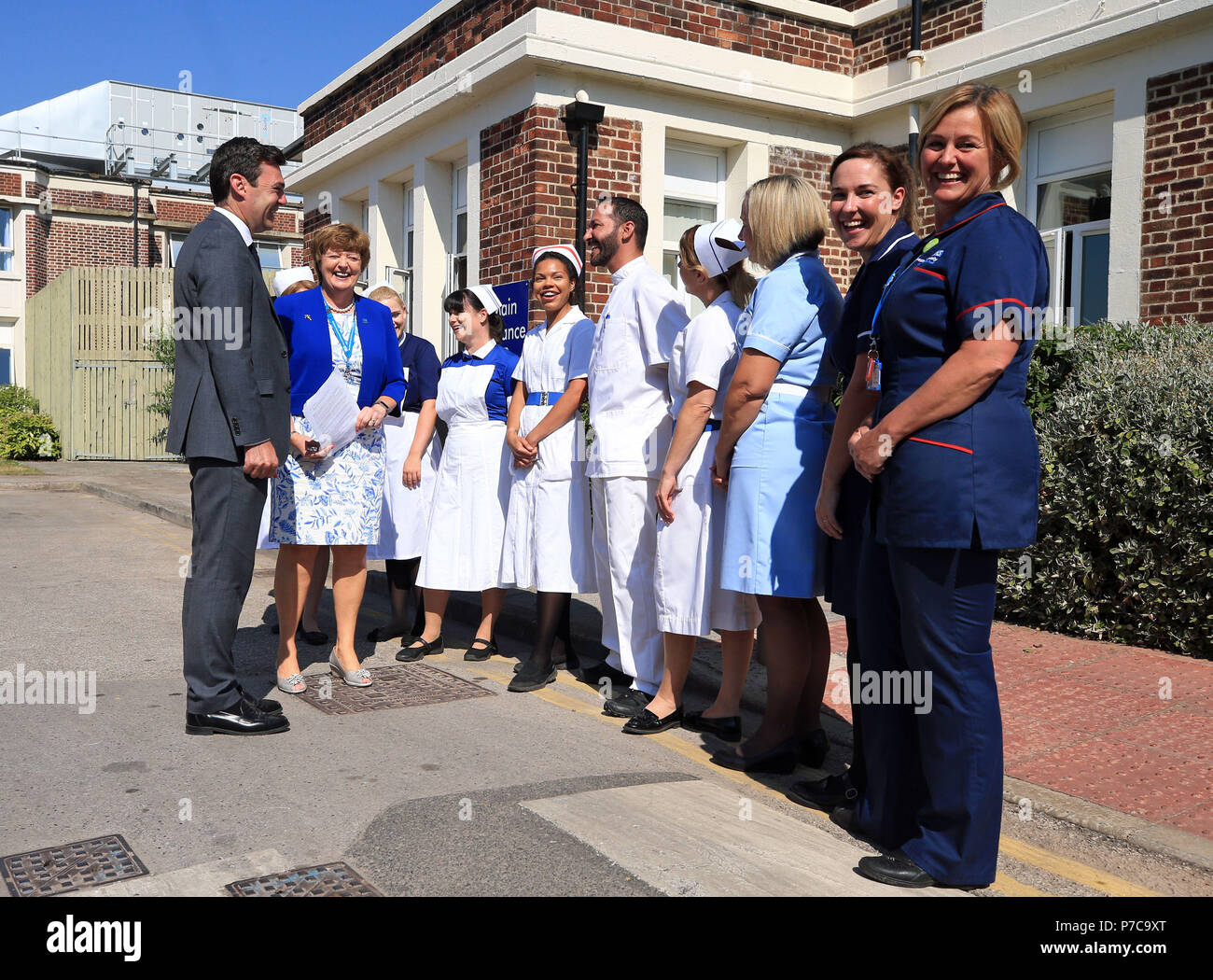 Mayor of Greater Manchester Andy Burnham meets nurses dressed in uniforms from the past 70 years, during a visit to Trafford General Hospital in Manchester to mark the 70th anniversary of the NHS. Stock Photo