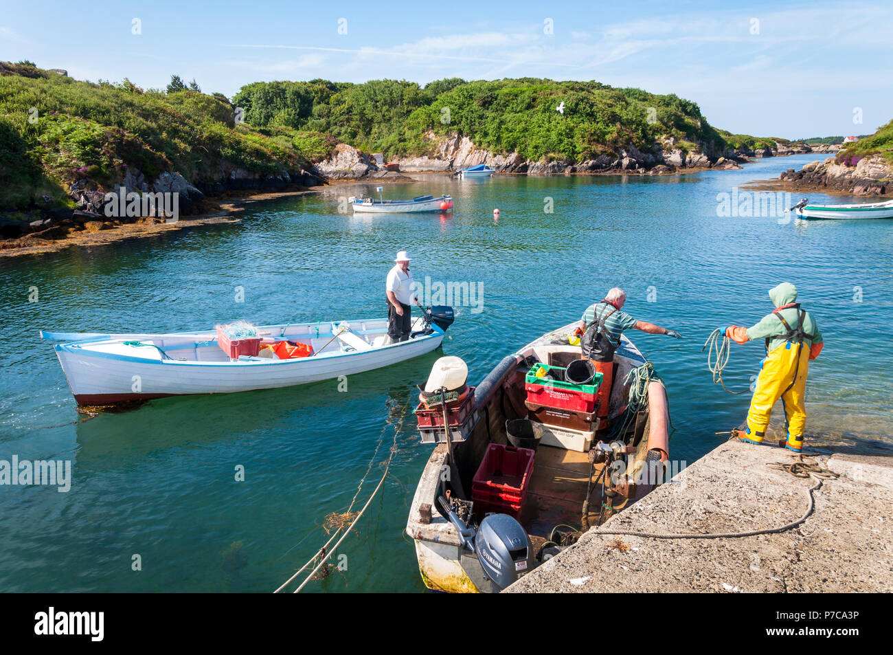 Lobster and crab fishermen return to Lackbeg Harbour near Burtonport, County Donegal, Ireland on a summer day. Stock Photo