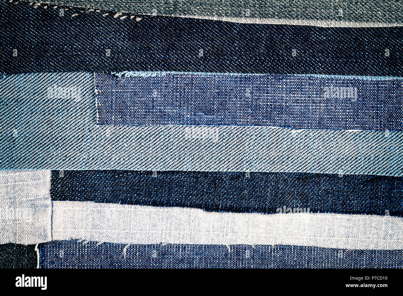 Abstract different torn jeans stripes texture background. Jeans texture. Striped jeans background. Denim jeans texture. Stock Photo