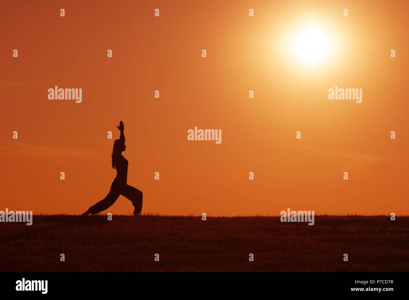 Silhouette of woman meditating in the sunset Stock Photo - Alamy