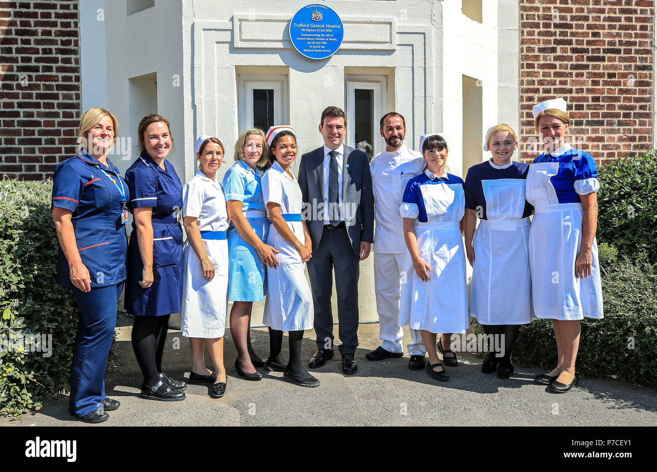 Mayor of Greater Manchester Andy Burnham, with nurses dressed in uniforms from the past 70 years, during his visit to Trafford General Hospital in Manchester to mark the 70th anniversary of the NHS. Stock Photo
