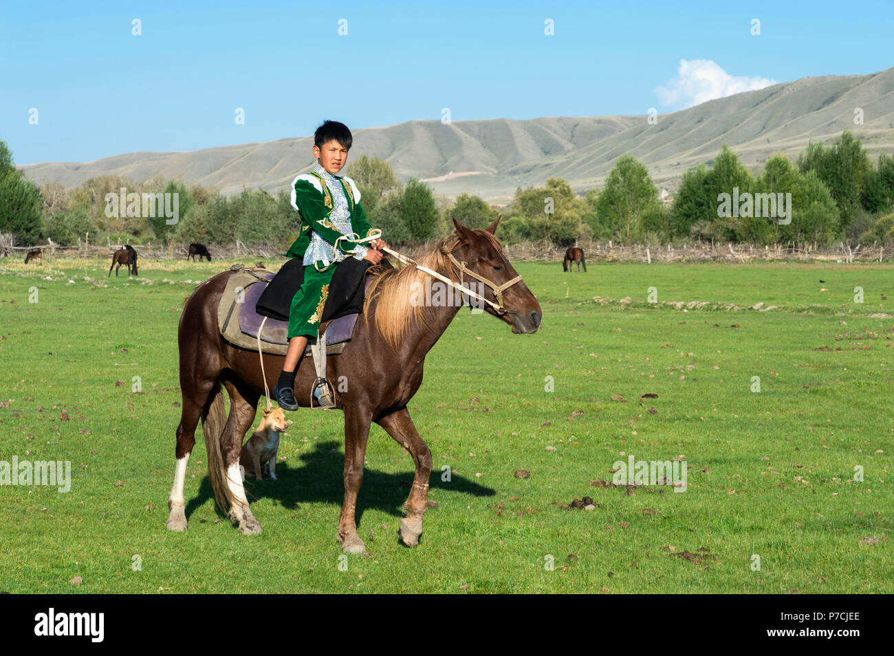 Kazakh boy in traditional clothes on a horse, Sati village, Tien Shan Mountains, Kazakhstan Stock Photo