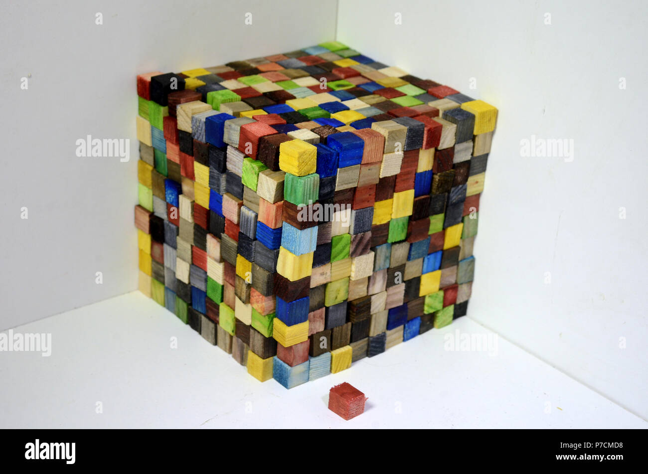 A cube made of colorful wood cubes, each cube is 1x1x1 centimeter, the wole cube consists of 1000 of such cubess, thus its volumen is 1000 cm^3 or one Stock Photo