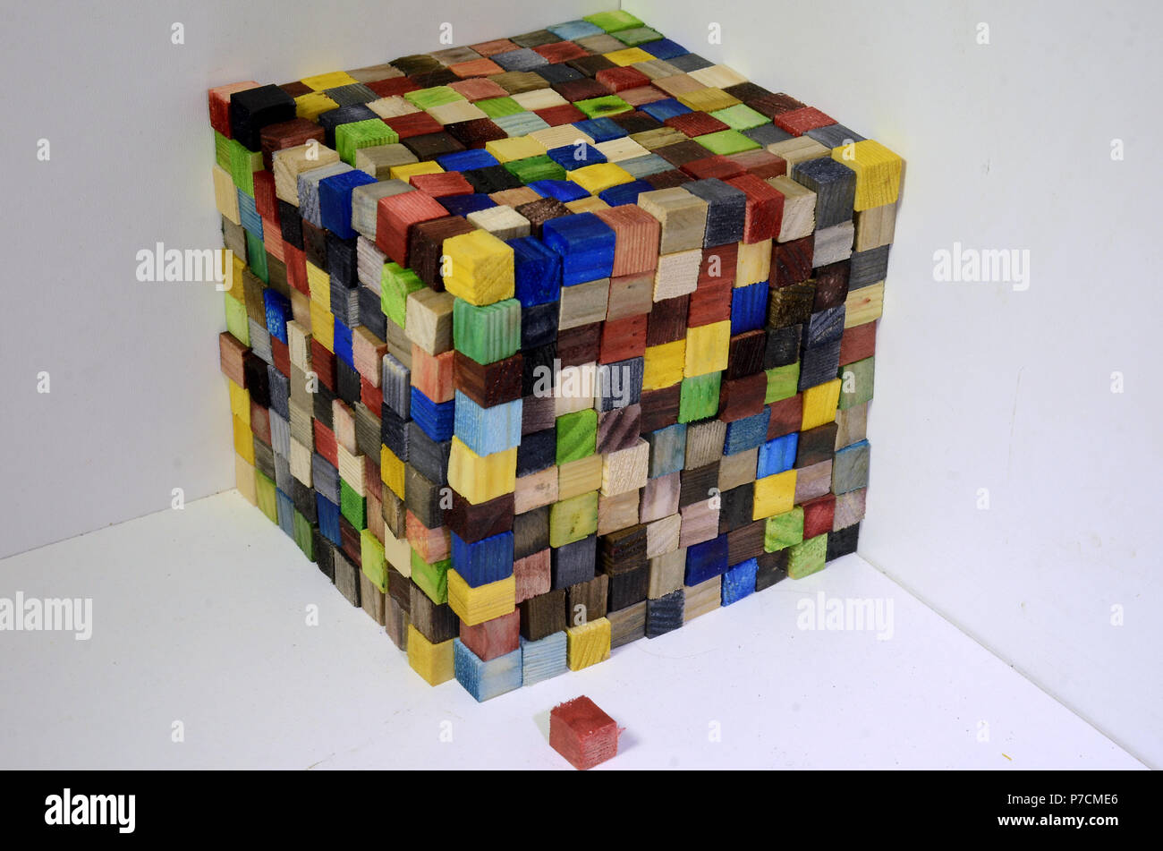 A cube made of colorful wood cubes, each cube is 1x1x1 centimeter, the wole cube consists of 1000 of such cubess, thus its volumen is 1000 cm^3 or one Stock Photo
