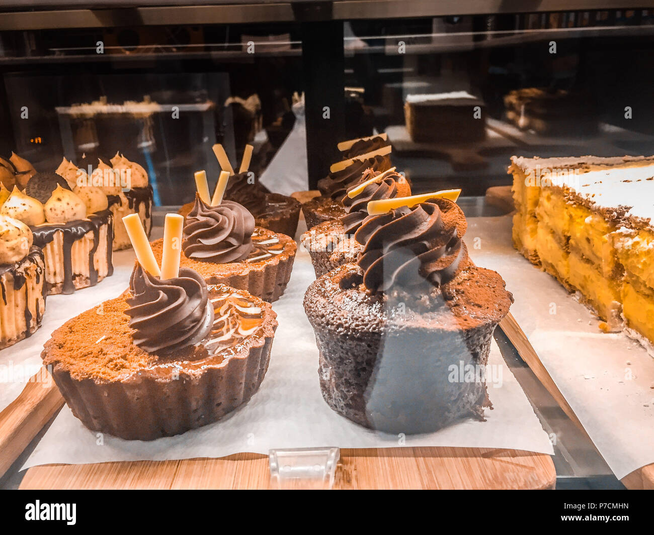 Delicious cupcakes displayed in eatery storefront window Stock Photo