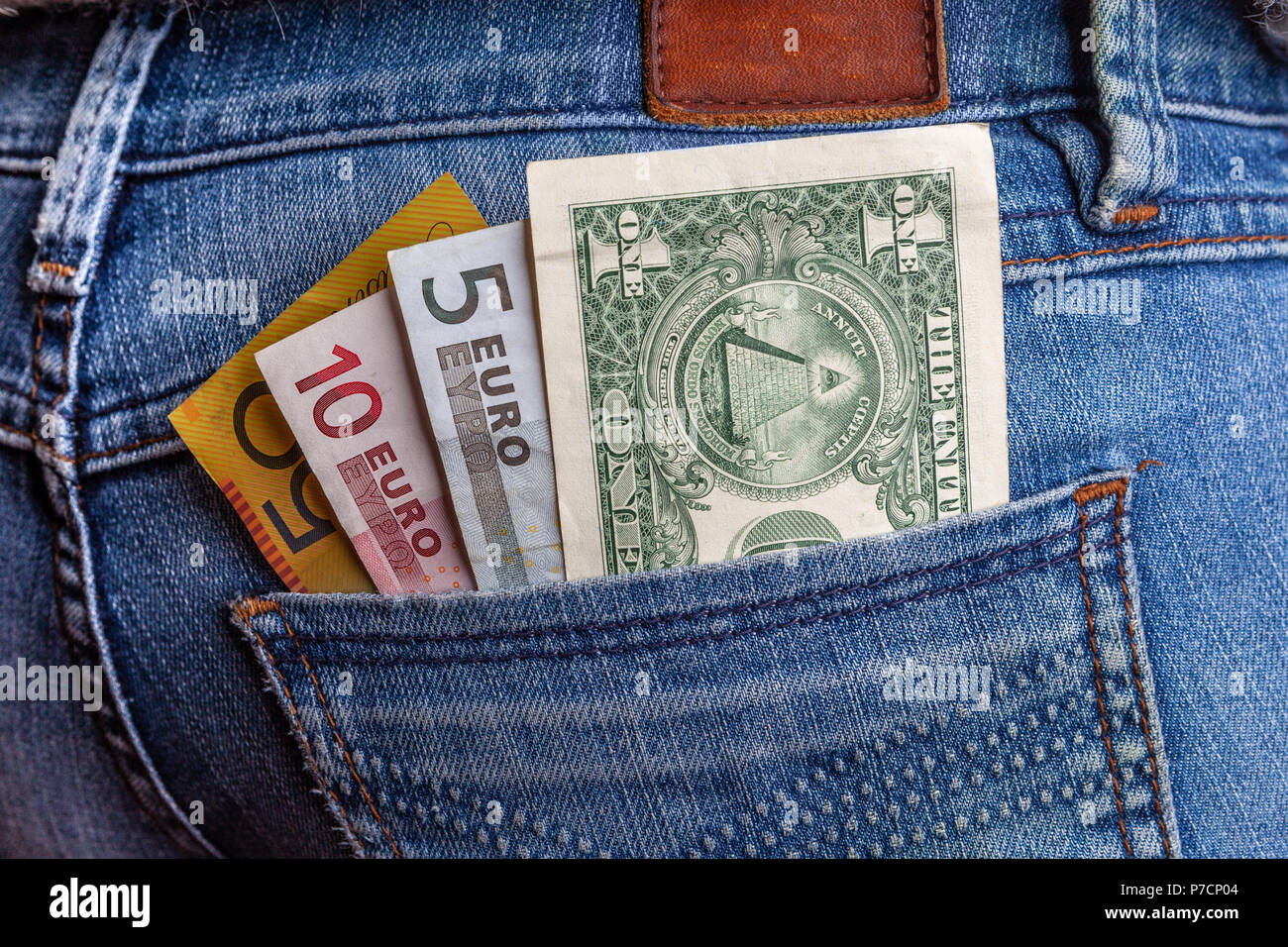 International travel and finance concept - USD, AUD, and EUR in back pocket of blue jeans Stock Photo