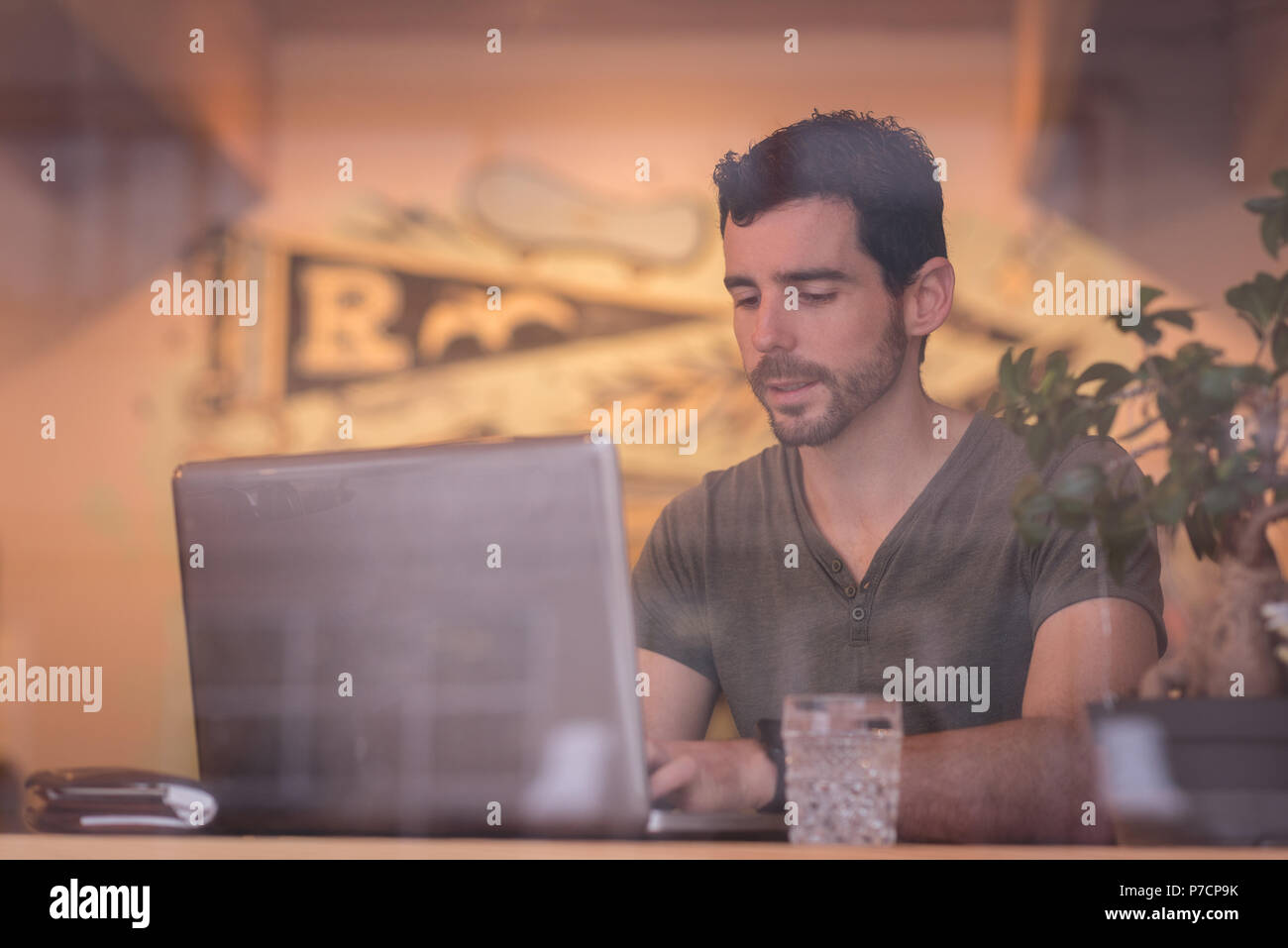 Man using laptop in cafe Stock Photo