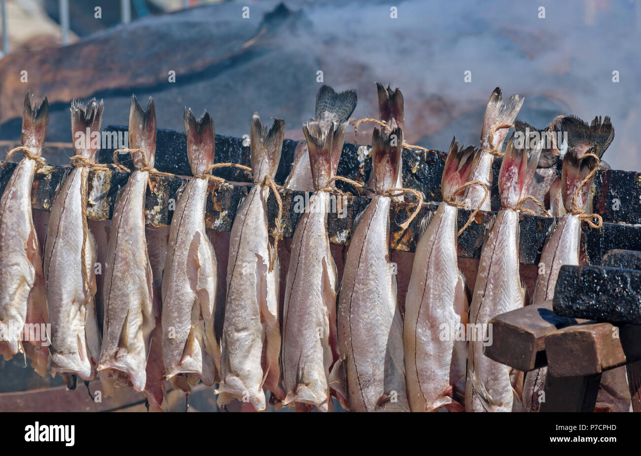 PORTSOY FESTIVAL ABERDEENSHIRE SCOTLAND ARBROATH SMOKIES HADDOCK FISH SMOKE FROM BARRELS OF FISH