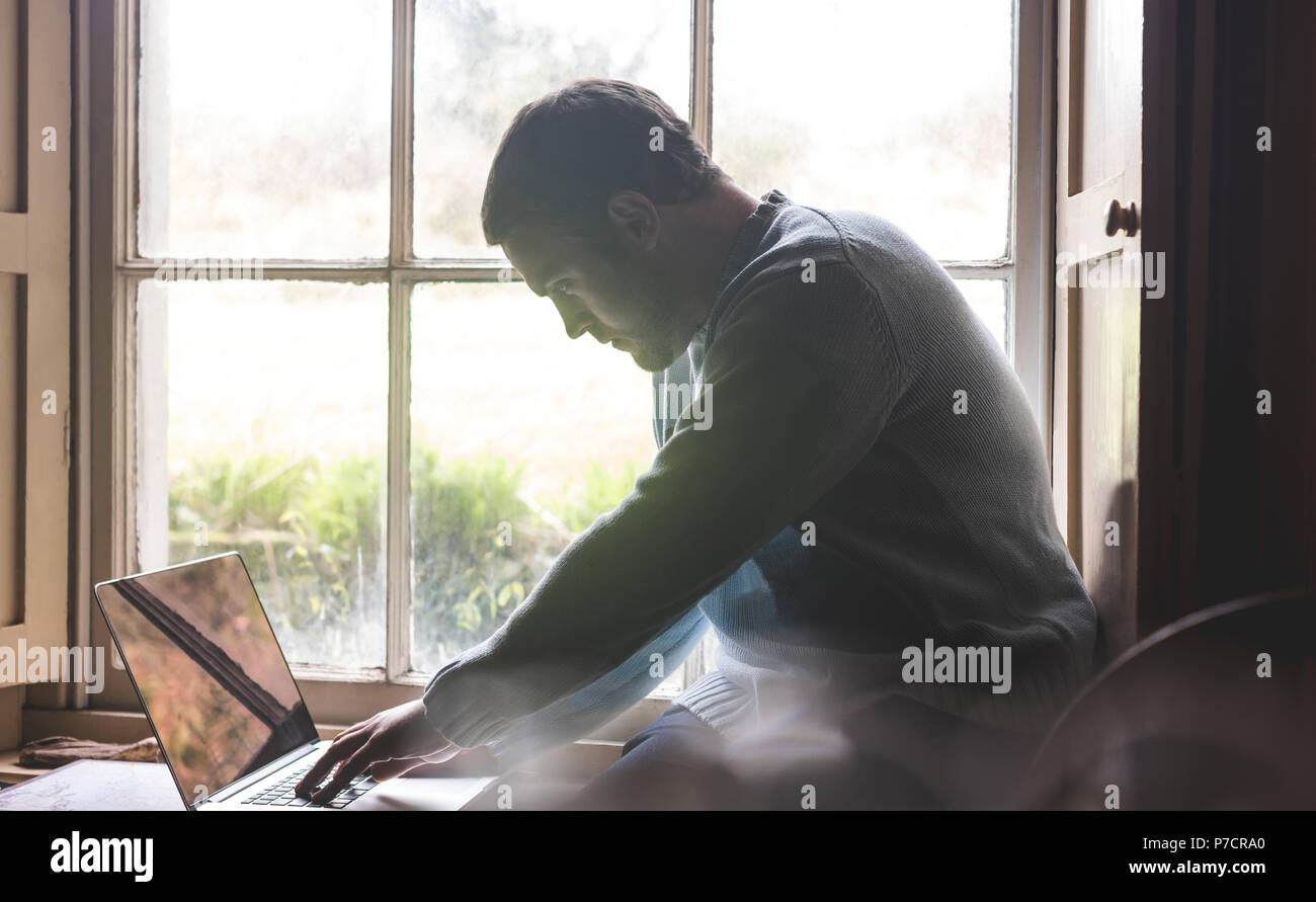 Man using laptop at home Stock Photo