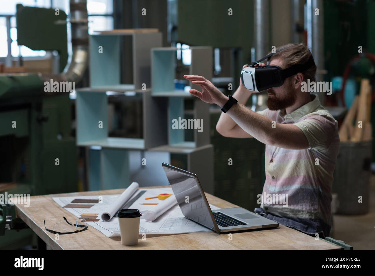 Male carpenter using virtual reality headset Stock Photo