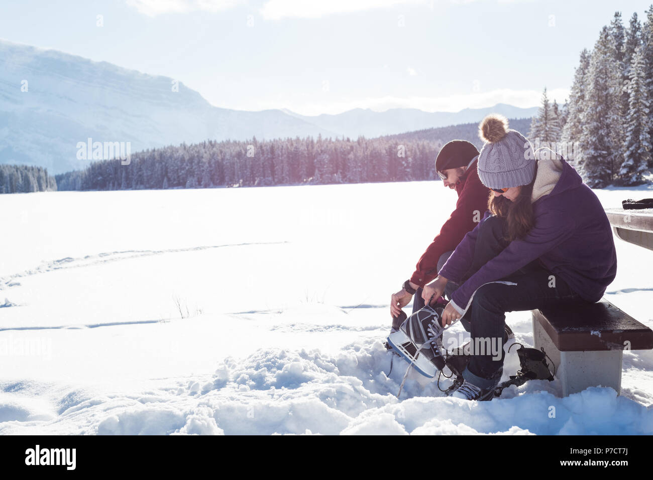 Couple wearing snow skate in snowy landscape Stock Photo