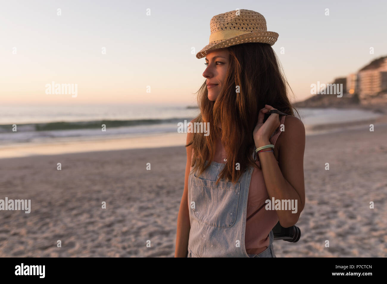Woman holding vintage camera in the beach Stock Photo - Alamy