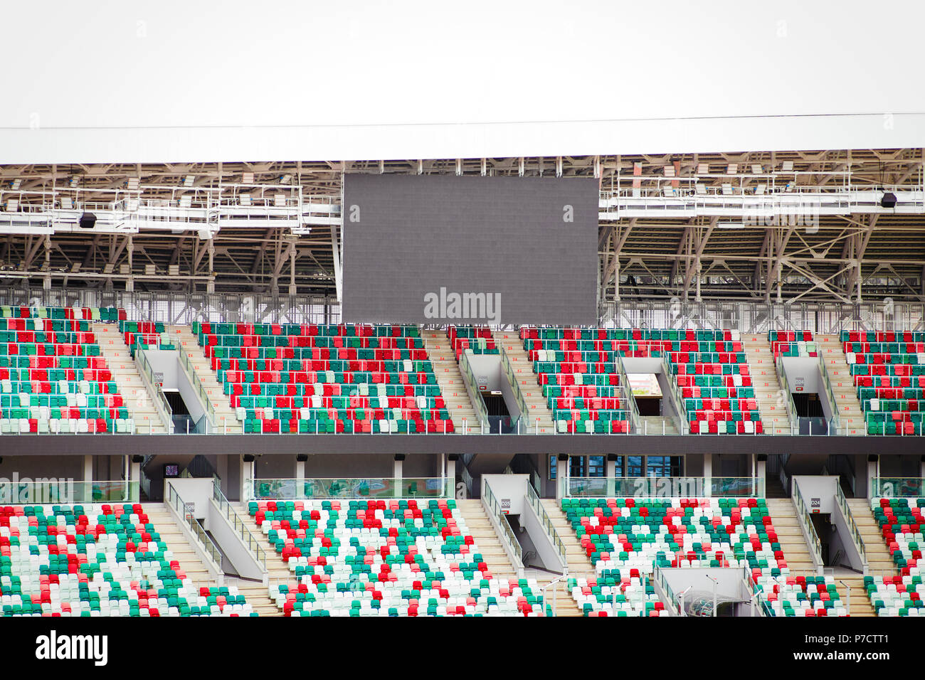 Empty stadium tribunes along with an empty black electronic scoreboard Stock Photo