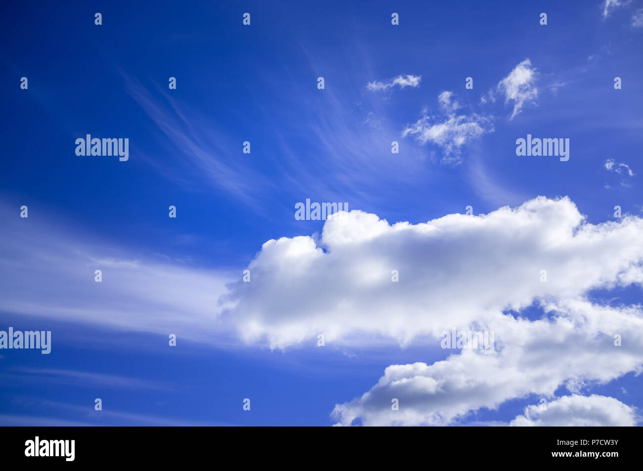Blue sky with white fluffy clouds on bright sunny day Stock Photo - Alamy