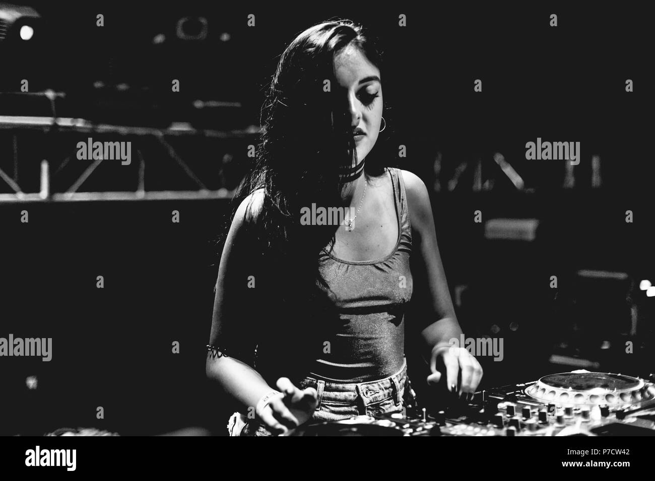 Young woman Dj playing music at Summer Night Festival. Fun, youth, entertainment and fest concept. Stock Photo