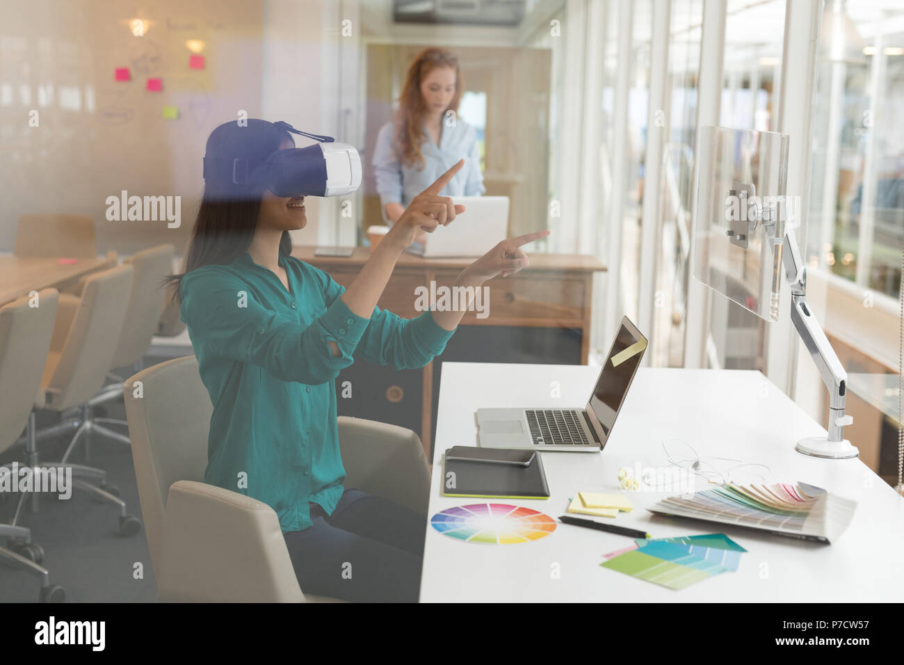 Female graphic designer using virtual reality headset Stock Photo