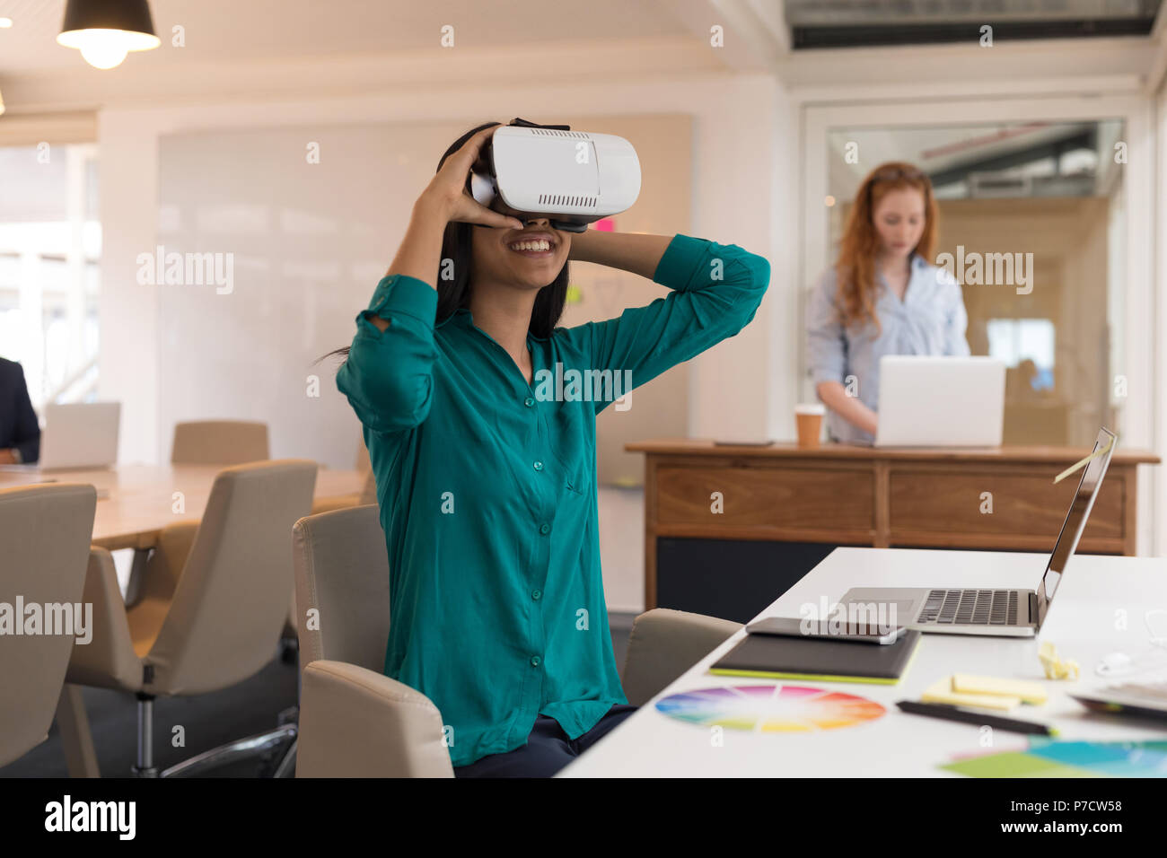 Female graphic designer using virtual reality headset Stock Photo