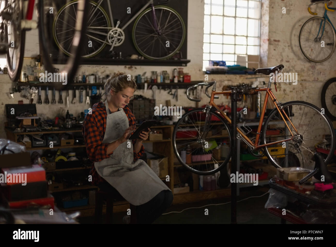 Female mechanic using digital tablet Stock Photo