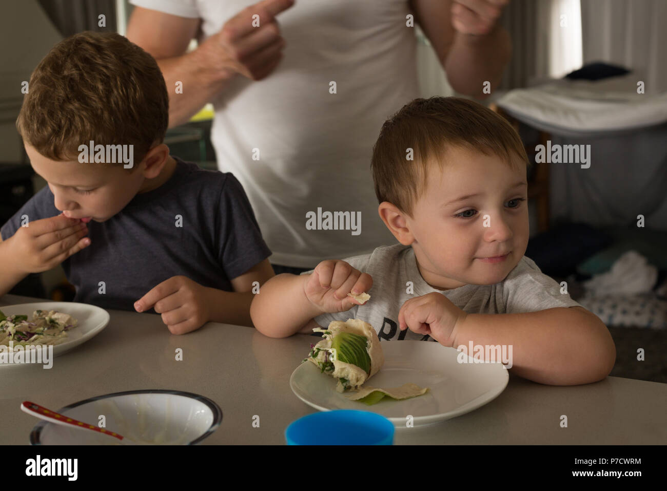Father and son having breakfast on a dinning table Stock Photo