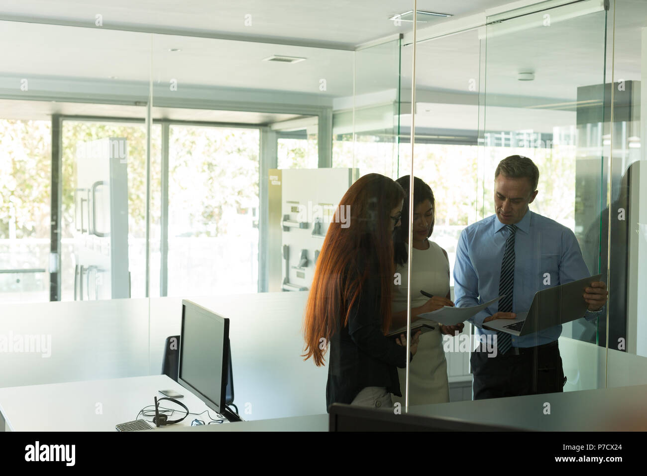 Business colleagues discussing over documents Stock Photo