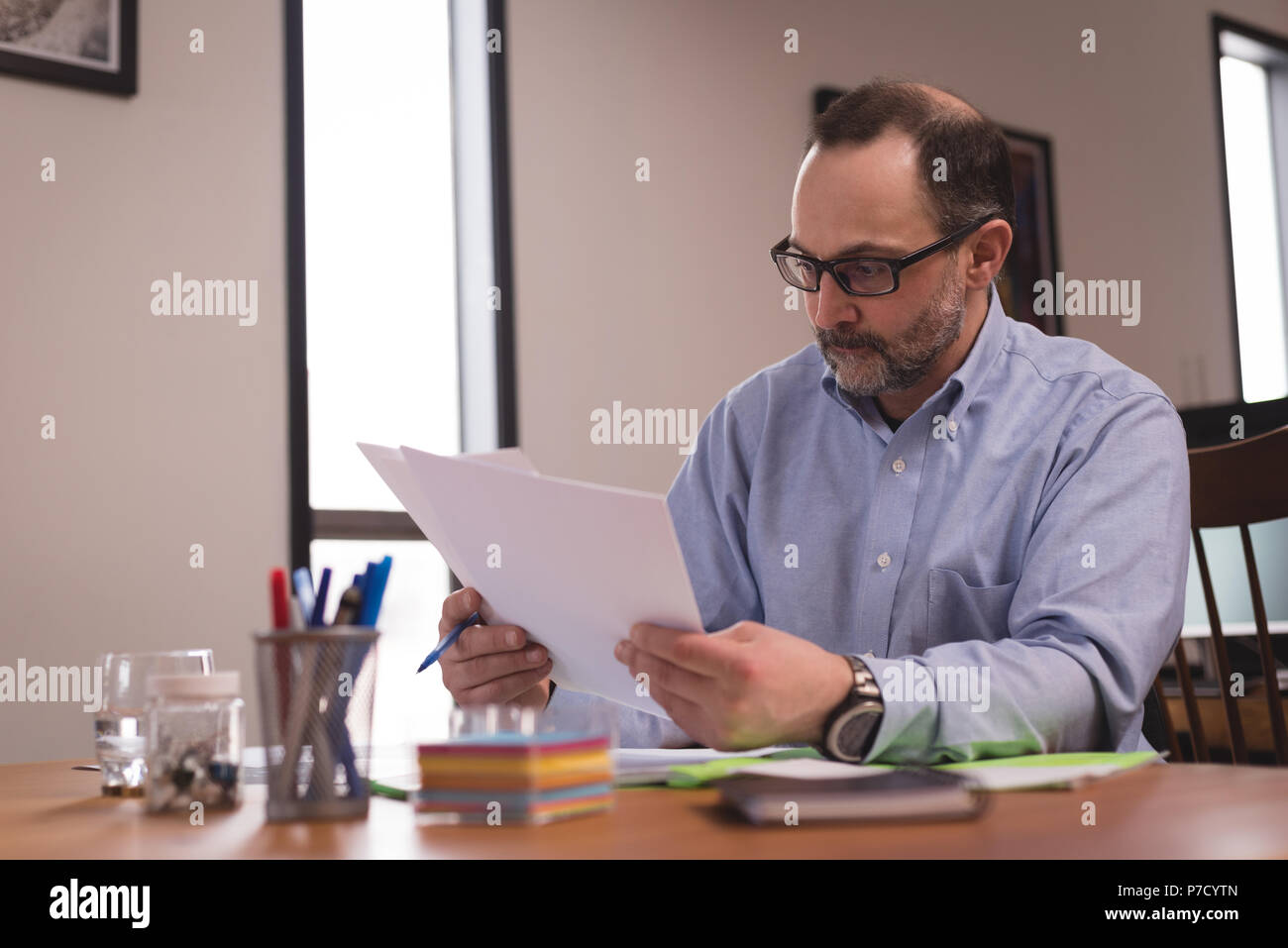 Male executive looking at documents Stock Photo