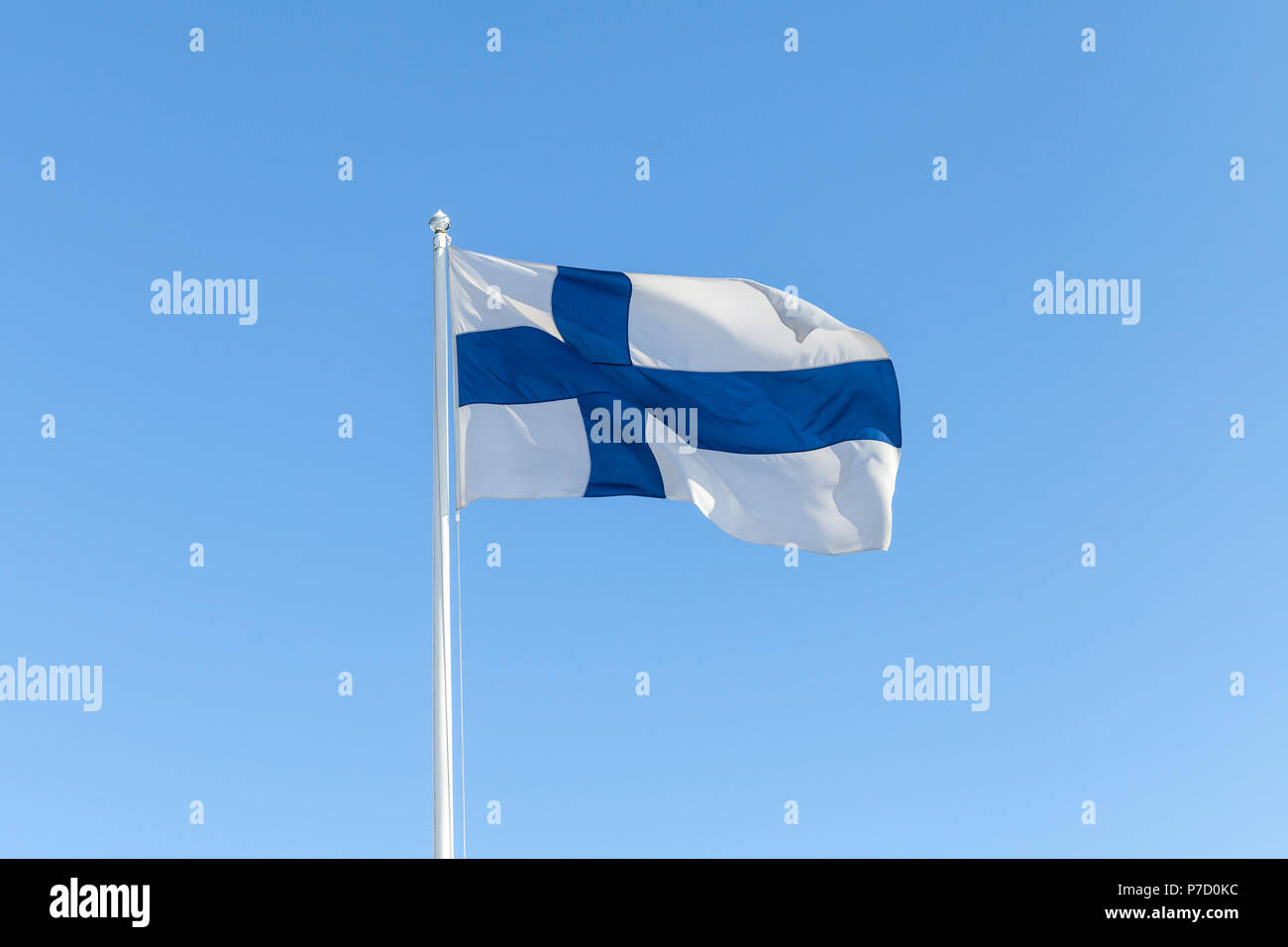 Flag of Finland, also called Blue Cross Flag waving over blue sky background Stock Photo