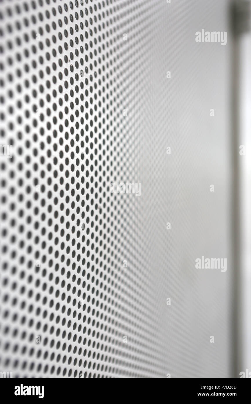 a creative white wall made from hole pattern metallic industrial sheet Stock Photo