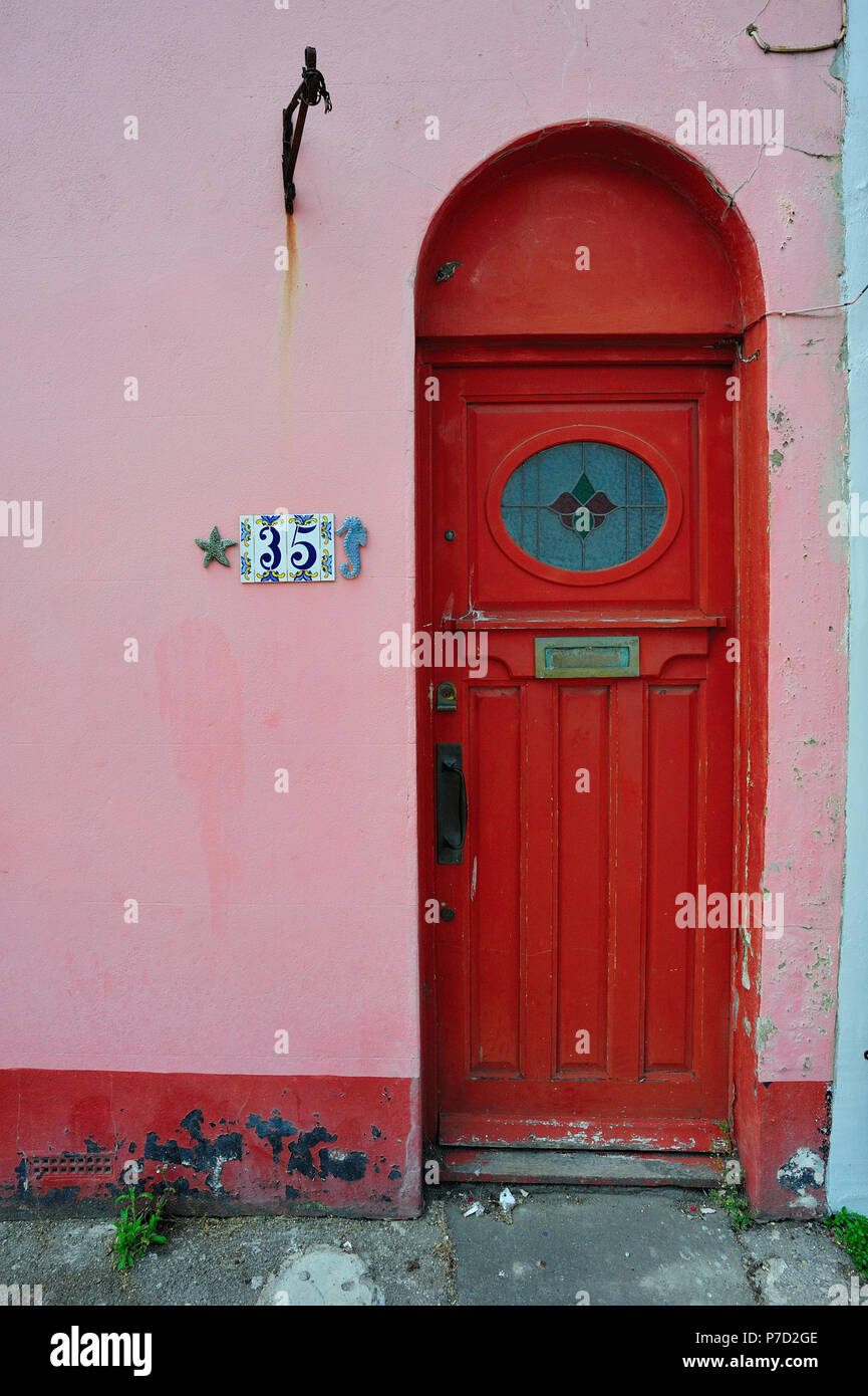 Weathered Red Door Of A Pink House In Brighton English Seaside