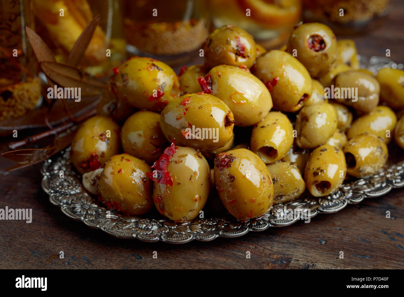 Green olives and bottles with olive oil on a wooden table Stock Photo ...