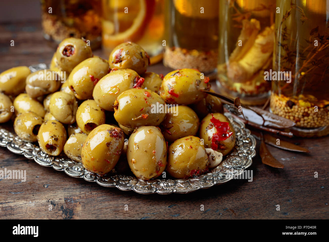 Green olives and bottles with olive oil on a wooden table Stock Photo ...