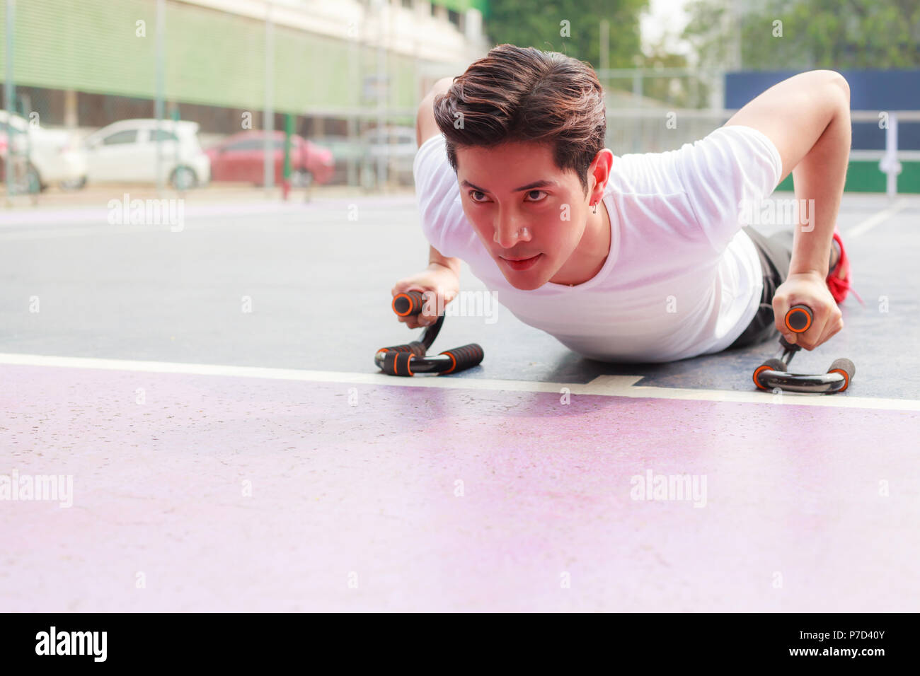 young handsome athlete man doing push up in fitness outdoor sport club ...