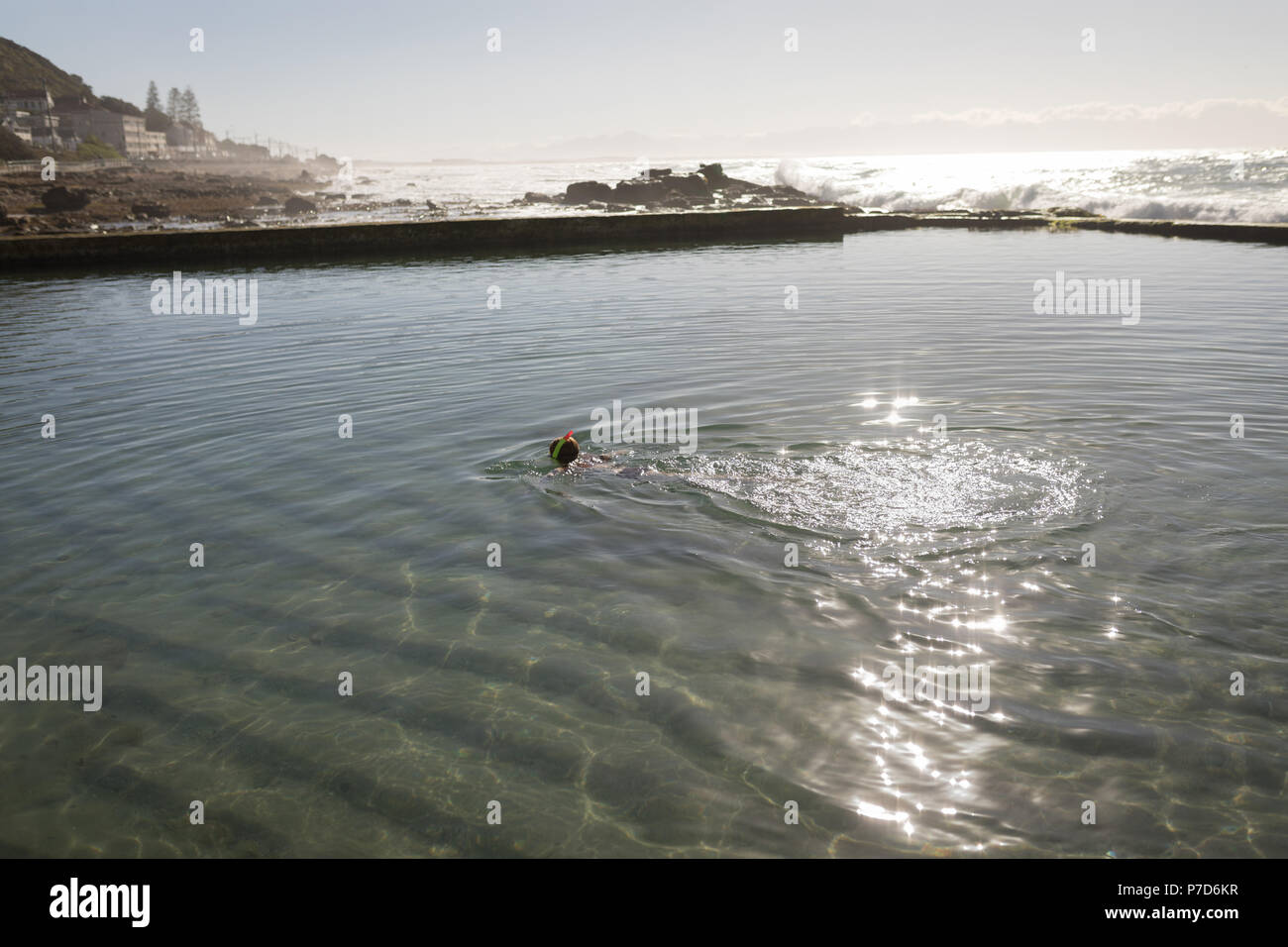 Woman swimming in the beachside pool Stock Photo