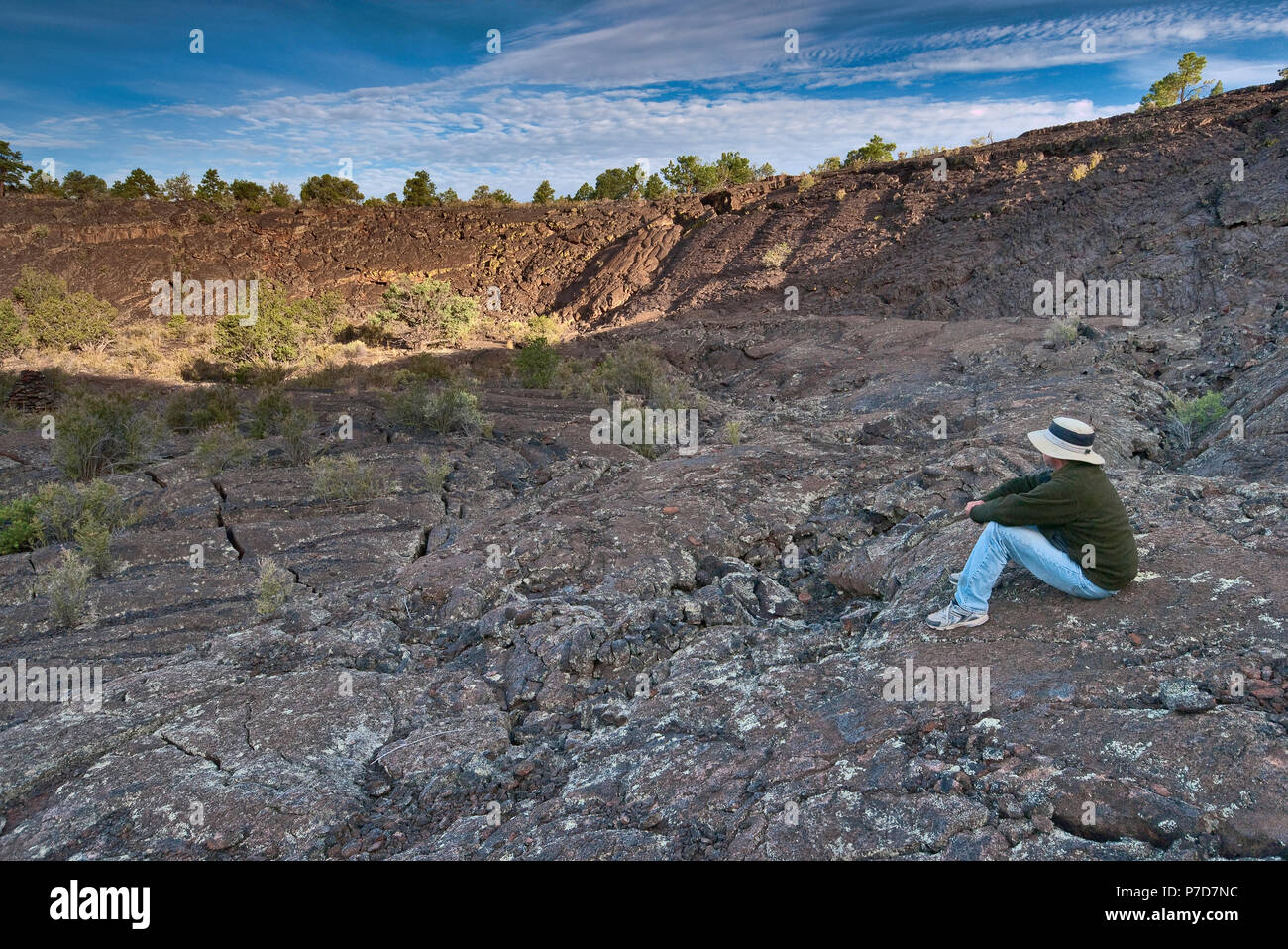 Hiker at volcanic Natural Amphitheater in Lava Falls Area at sunrise, El Malpais National Monument, New Mexico, USA Stock Photo