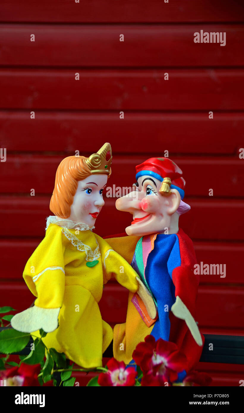 Punch puppets, Punch and Judy, princess, sitting on a metal fence Stock