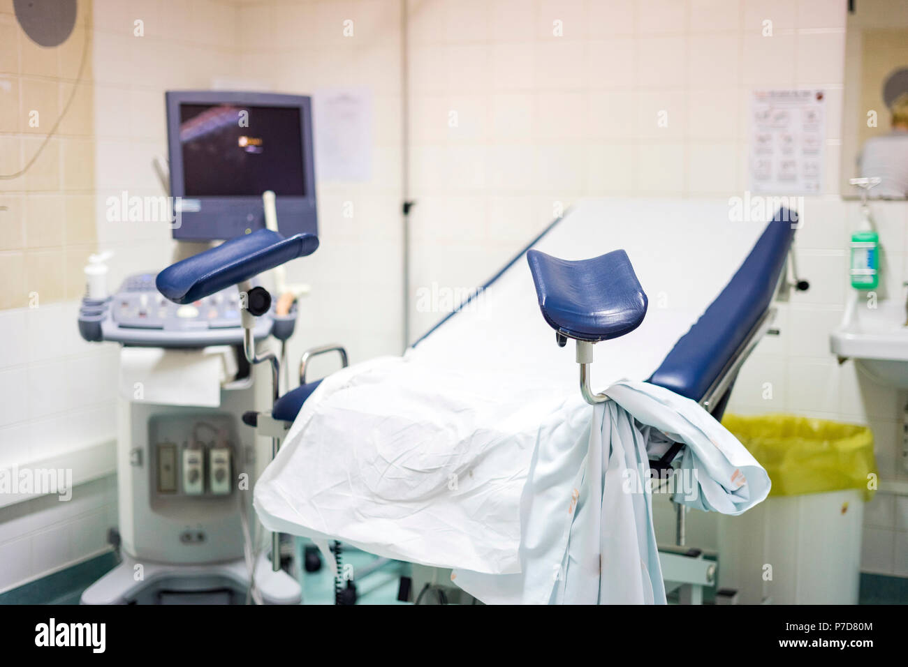 Navy blue gynecological chair with ultrasound monitor in the hospital Stock Photo