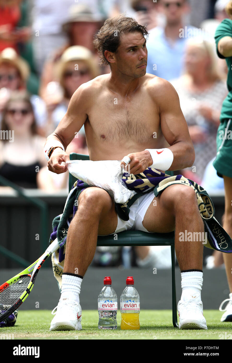 Rafael Nadal changes his shirt during a change of ends on day four of the Wimbledon Championships at the All England Lawn Tennis and Croquet Club, Wimbledon. PRESS ASSOCIATION Photo. Picture date: Thursday July 5, 2018. See PA story TENNIS Wimbledon. Photo credit should read: John Walton/PA Wire. Stock Photo