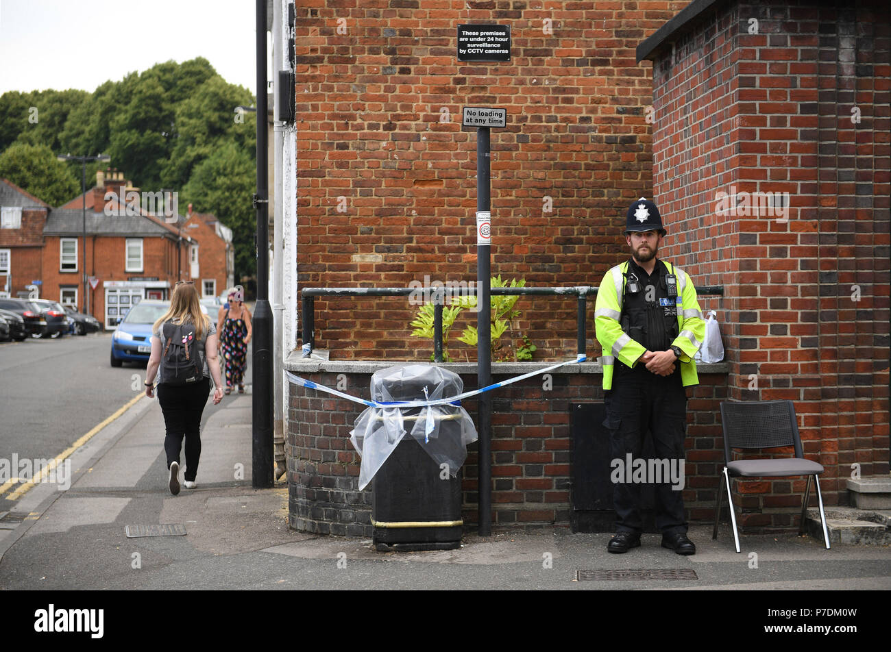 RETRANSMITTED CORRECTING TOWN A police officer by a sealed off litter bin in Rollestone Street, Salisbury, Wiltshire, where counter-terrorism police are investigating after a couple were left in a critical condition when they were exposed to the nerve agent Novichok. Stock Photo