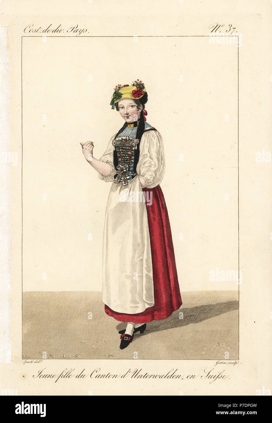 Young girl of the Canton of Unterwalden (now Obwalden and Nidwalden), Switzerland, 19th century. She wears a hat adorned with flowers and ribbons, a cap with ribbons, and an embroidered bib decorated with pearl rosettes (this is sometimes only painted cardboard). Handcoloured copperplate engraving by Georges Jacques Gatine after an illustration by Louis Marie Lante from Costumes of Various Countries, Costumes de Divers Pays, Paris, 1827. Stock Photo