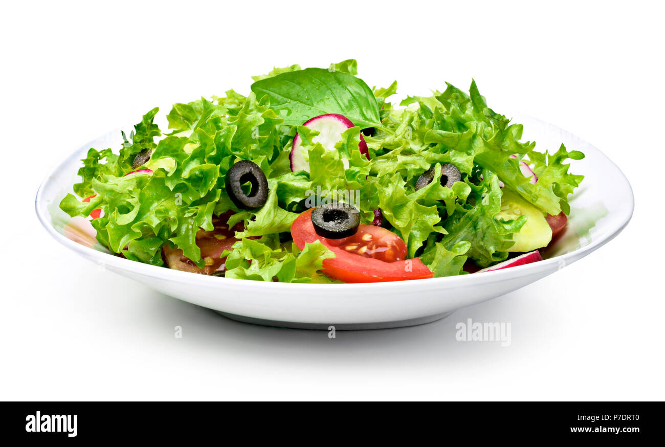 Delicious fresh salad dish on a white plate, isolated on white background. Healthy eating scene, fresh lettuce, tomatoes, cucumber and olives in a bow Stock Photo