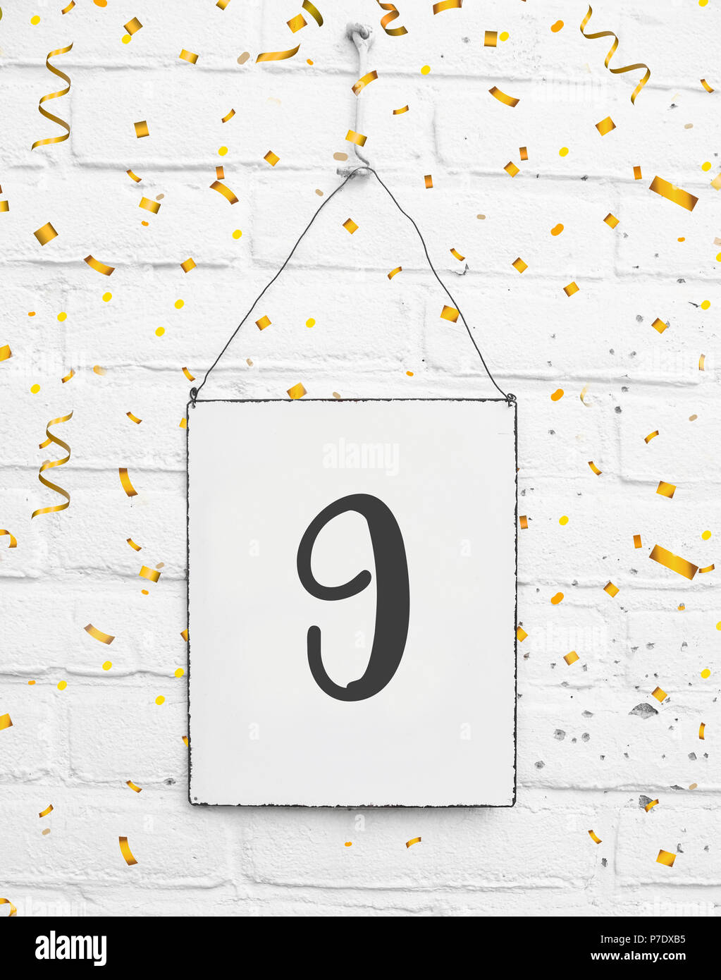 9 years old birthday party card text with golden confetti, number nine Stock Photo
