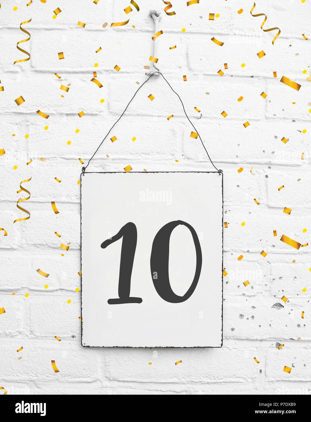 10 years old birthday party card text with golden confetti, number ten Stock Photo