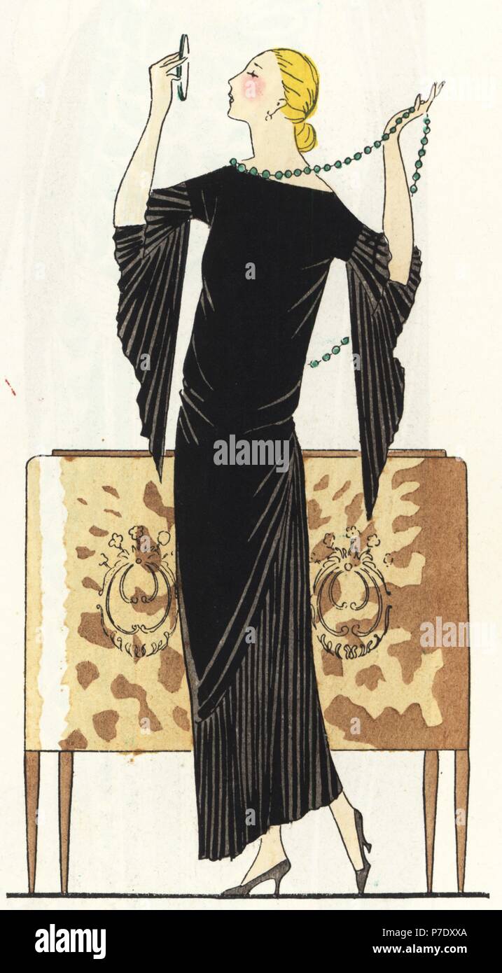 Woman with mirror and necklace wearing a dress in black satin crepe draped a la Grecque. Handcolored pochoir (stencil) lithograph from the French luxury fashion magazine Art, Gout, Beaute, 1923. Stock Photo