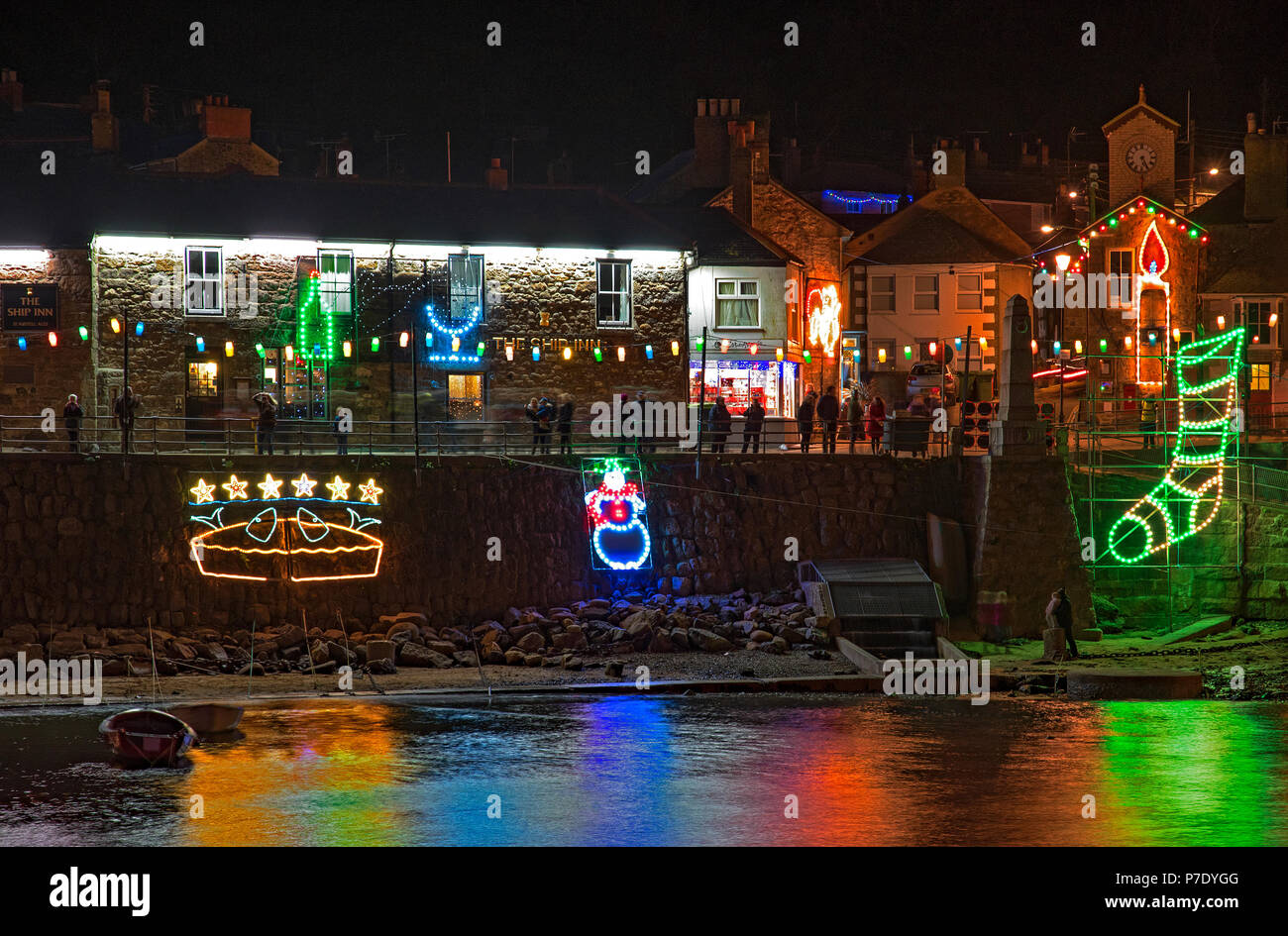 christmas festive lights around the harbour in mousehole, cornwall
