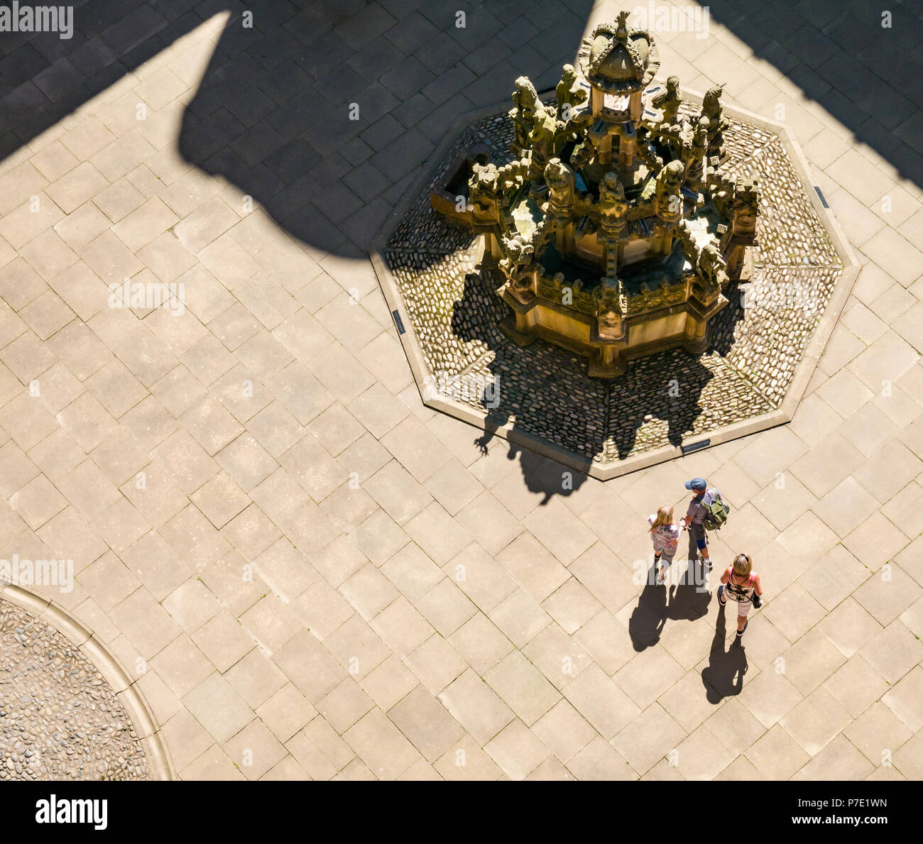 Looking down to central courtyard with ornate stone fountain with people’s shadows in Summer sunshine, Linlithgow Palace, West Lothian, Scotland, UK Stock Photo