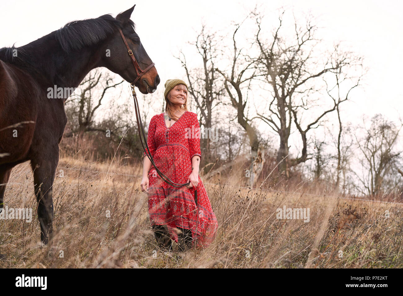 Woman standing with horse Stock Photo