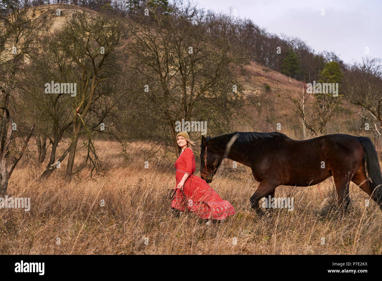 Woman walking with horse Stock Photo