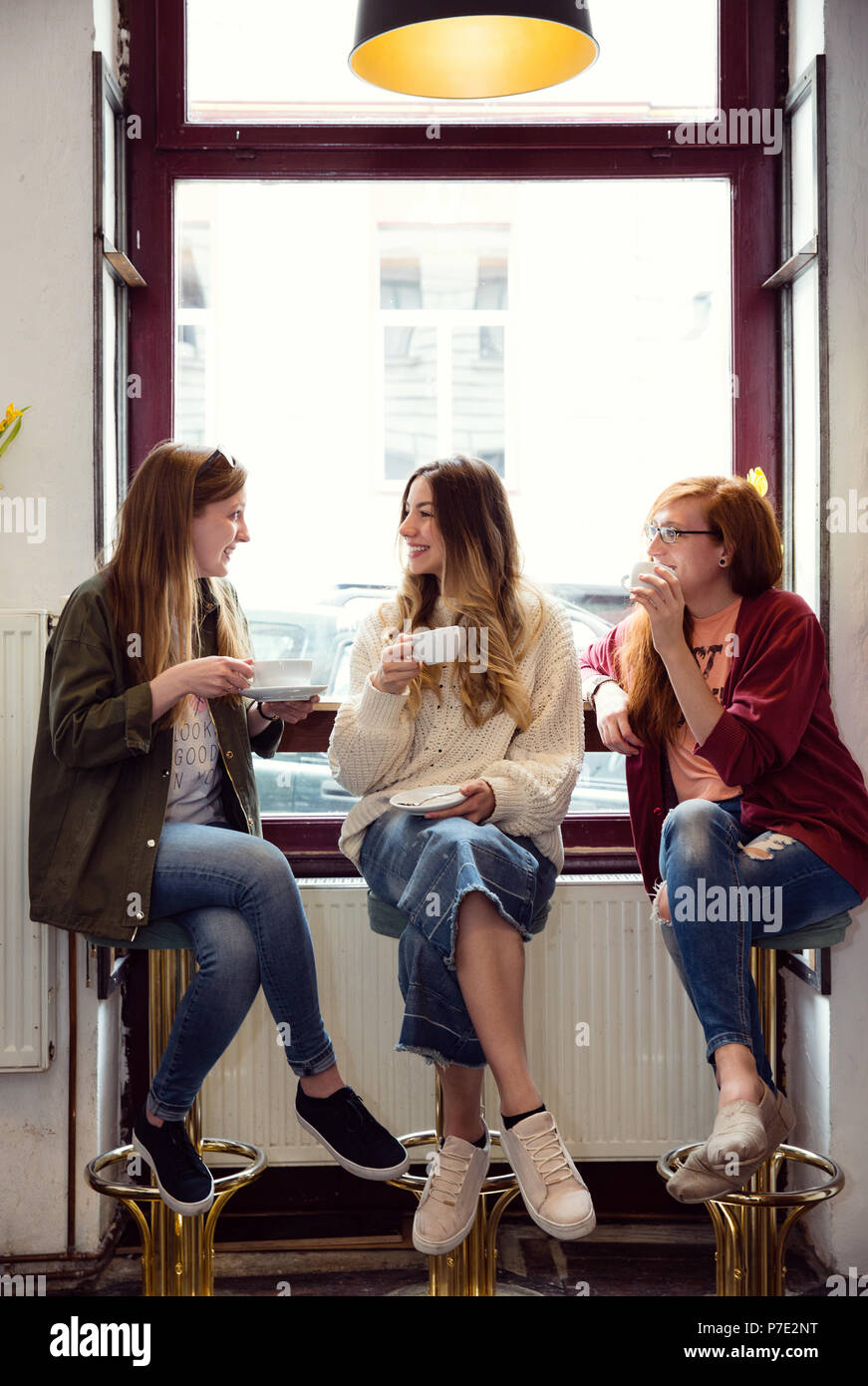 Young women chatting over coffee in cafe Stock Photo