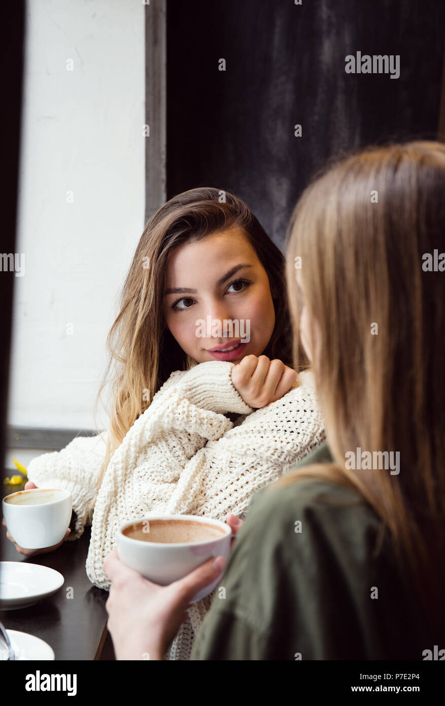Young women chatting over coffee in cafe Stock Photo