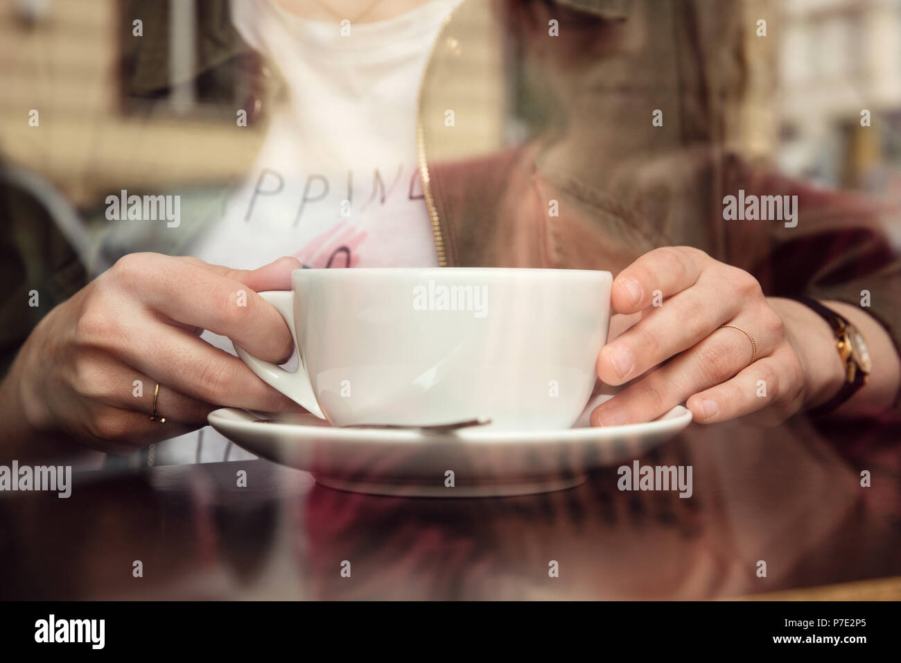 Young woman having coffee in cafe Stock Photo