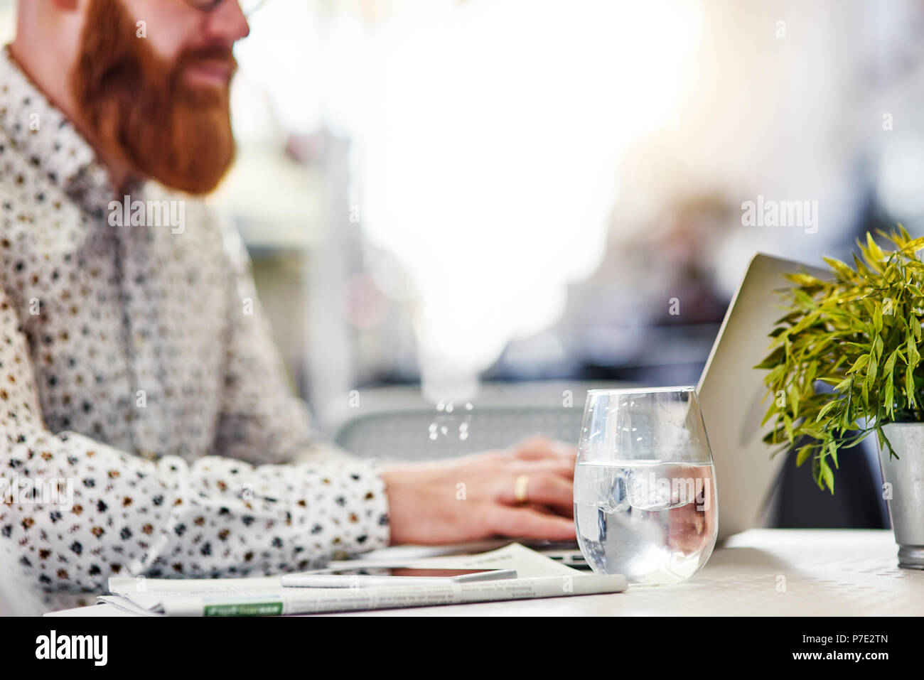 Bearded man using laptop Stock Photo